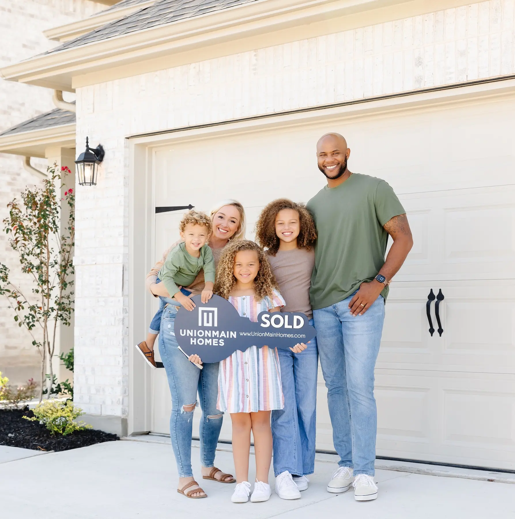 A family celebrating the purchase of their new UnionMain home