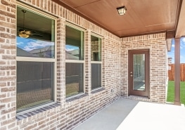 A brick patio with a sliding glass door.