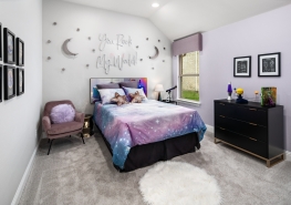 A bedroom with purple walls and a bed with stars on it.