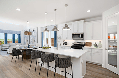 A kitchen with white cabinets and a large island, navigating current mortgage rates to explore your options.