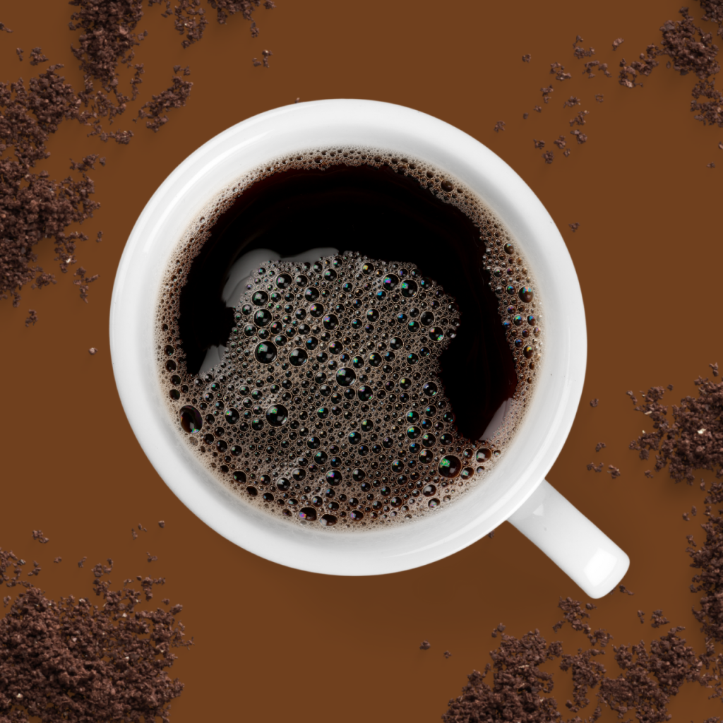 A cup of coffee on a brown background.